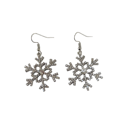 Snowflake-shaped earrings with rhinestones on a light gray background