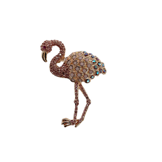 Flamingo-shaped brooch with gemstones on a light background