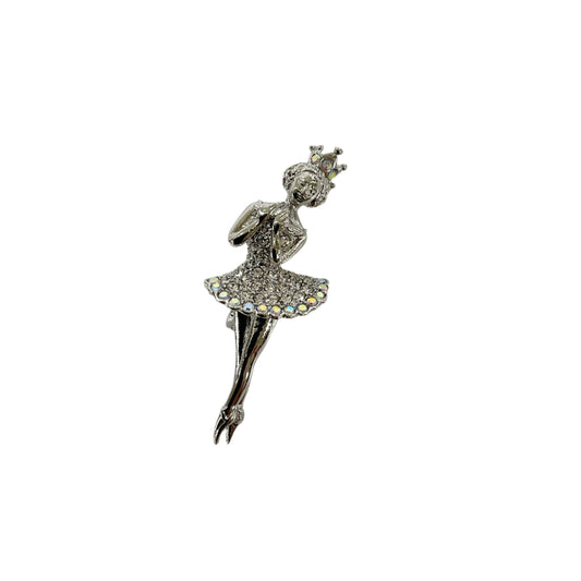 Silver ballerina brooch on a light gray background